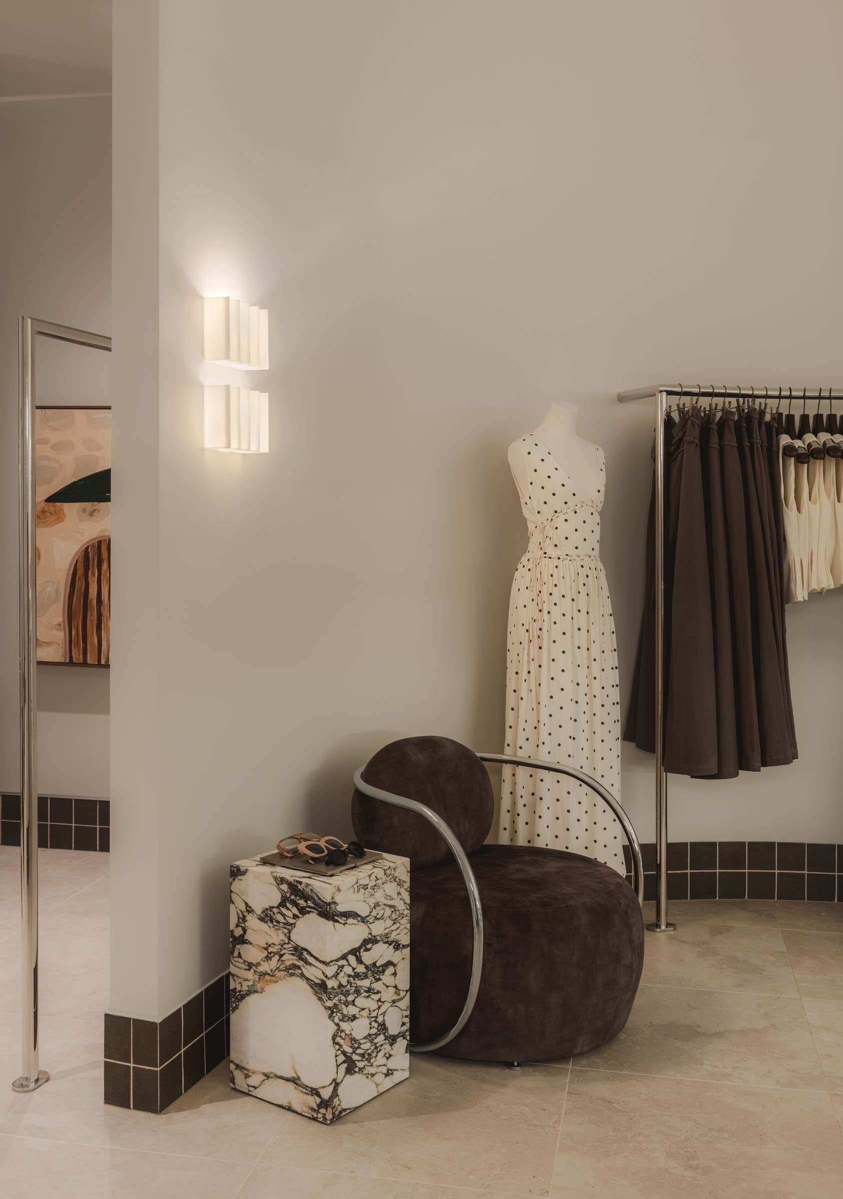 Curated fashion display at Sabo Sunshine Plaza featuring sculptural furniture, soft lighting and contemporary retail interior design.