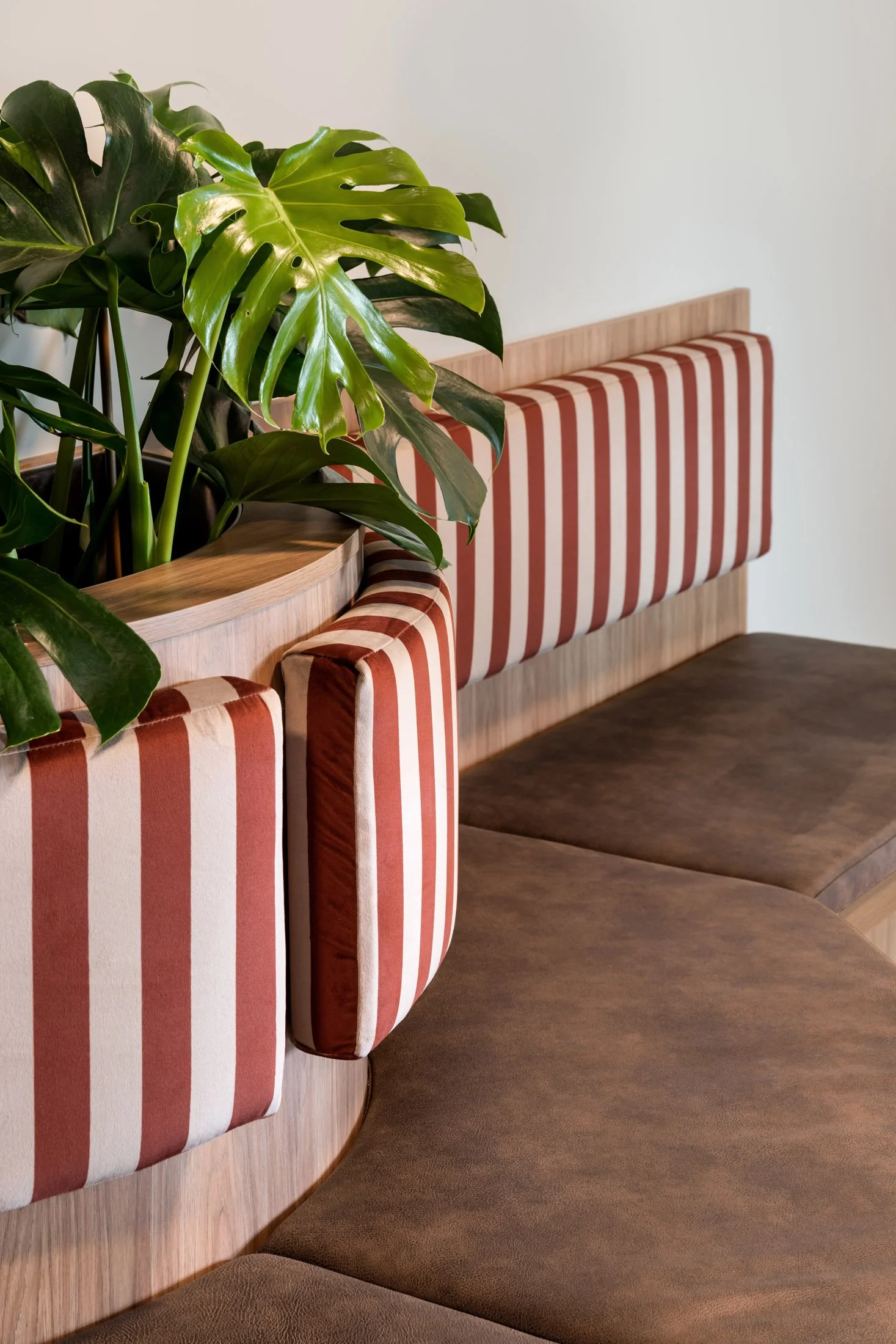 Custom banquette seating and patterned screens at Whaleback Golf Course