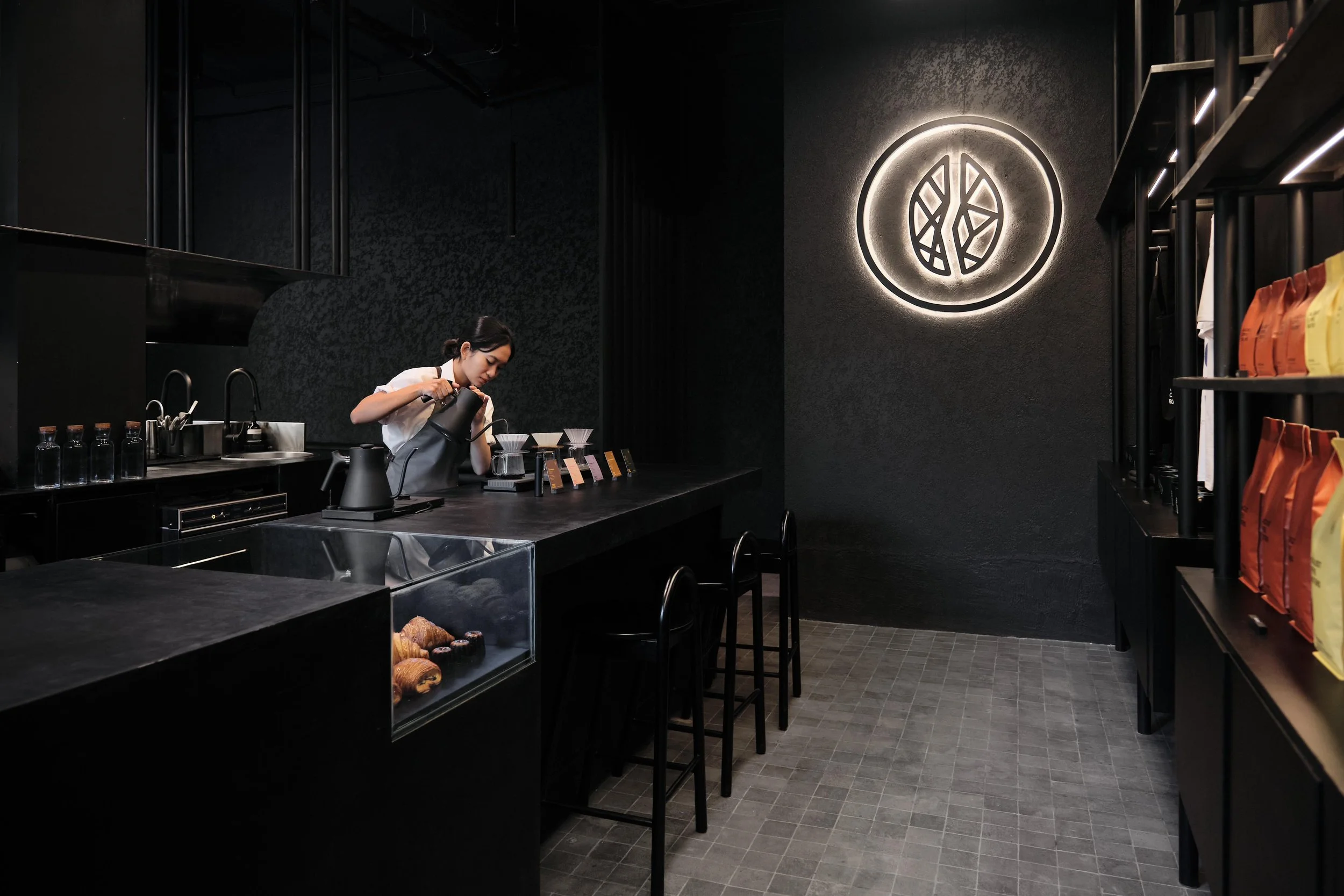Blacklist Coffee Roasters Bali interior featuring a moody monochromatic palette, custom steel detailing and immersive specialty coffee design by Collectivus.