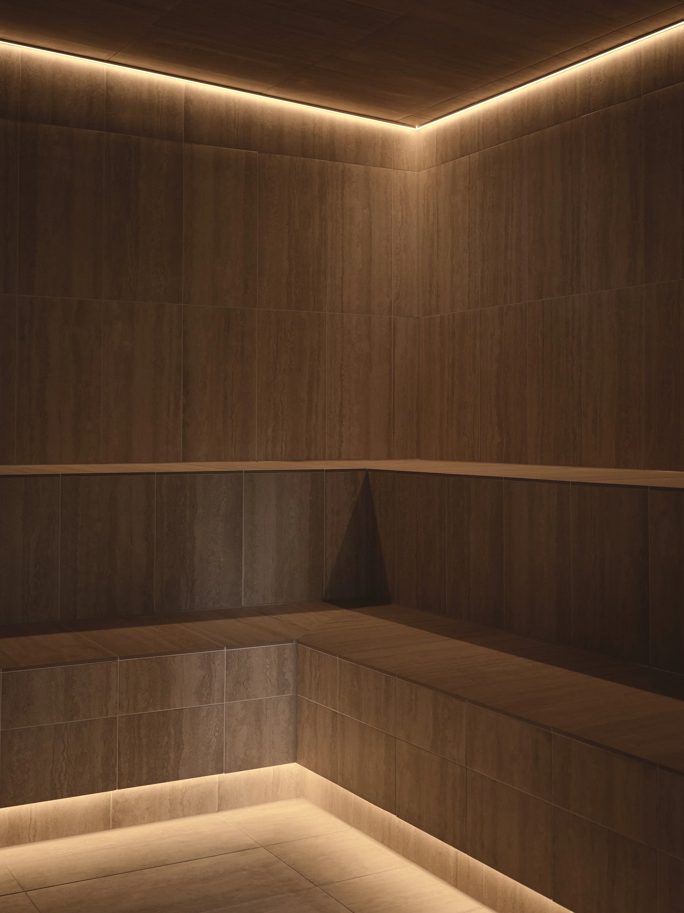 Luxury steam room with natural stone finishes and soft mood lighting