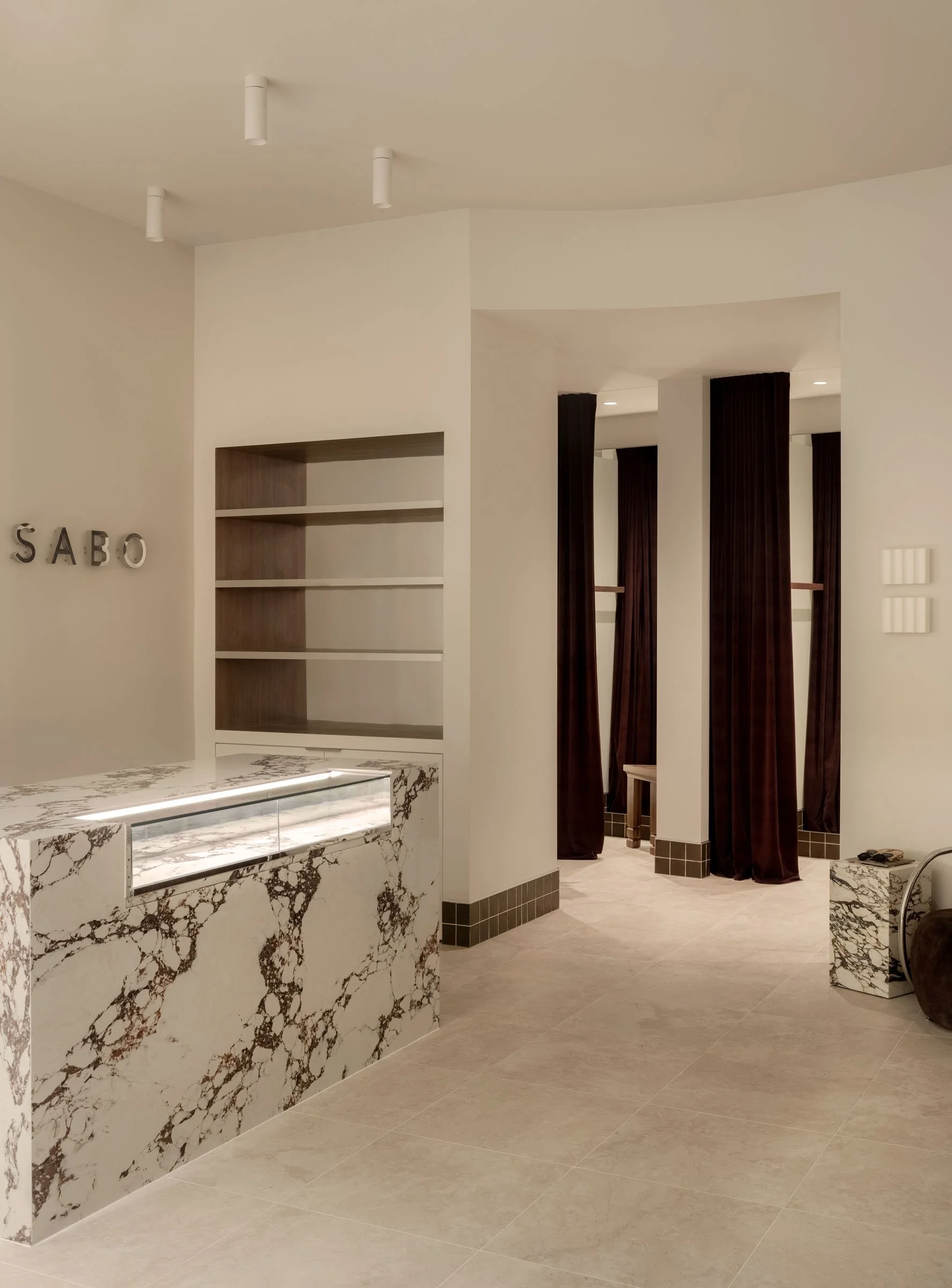 Sabo Sunshine Plaza retail interior featuring a statement stone counter, soft neutral palette and refined fashion boutique design.