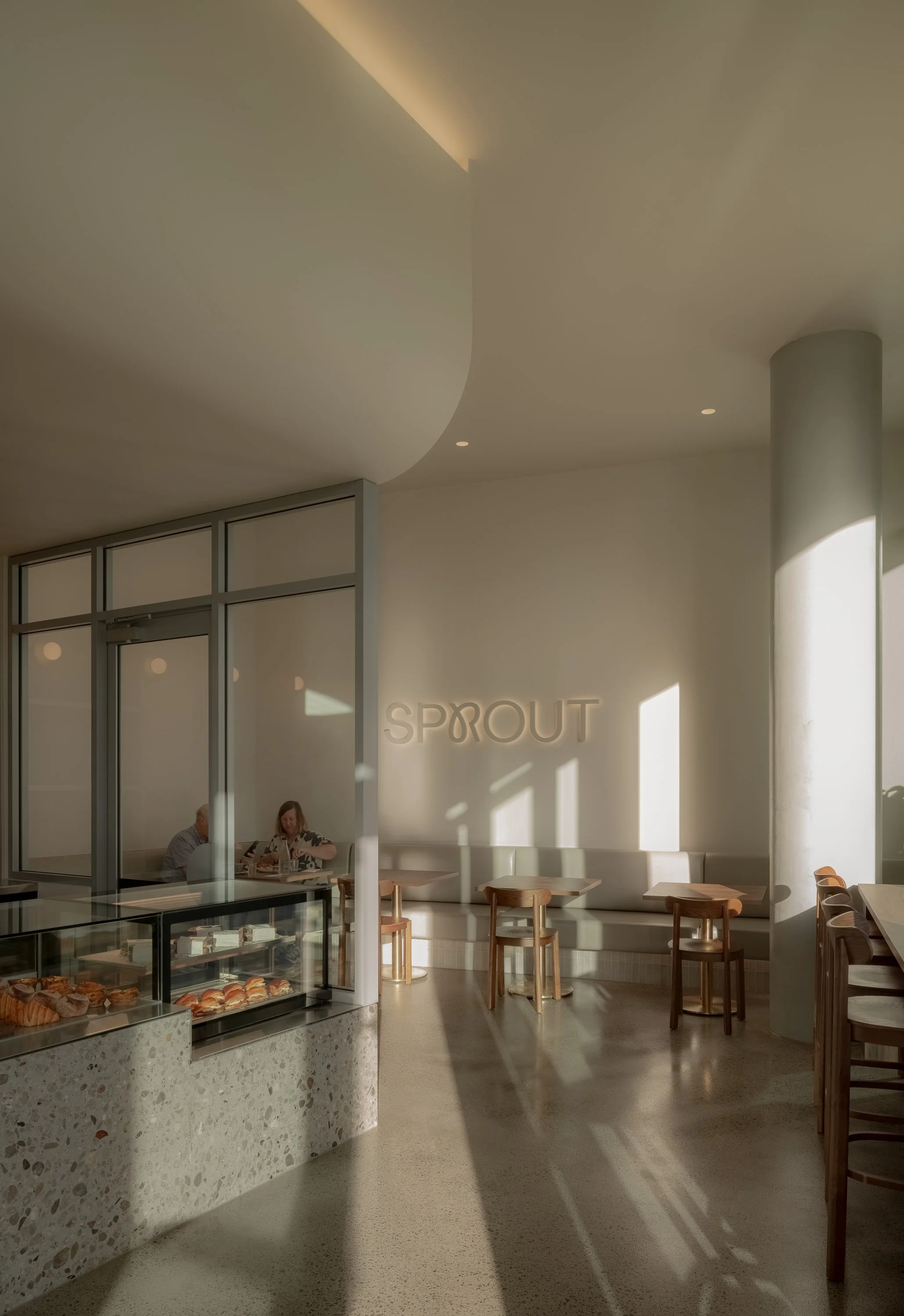 Coffee service counter at Sprout Bakery Brisbane featuring custom joinery, integrated POS and contemporary hospitality interior design
