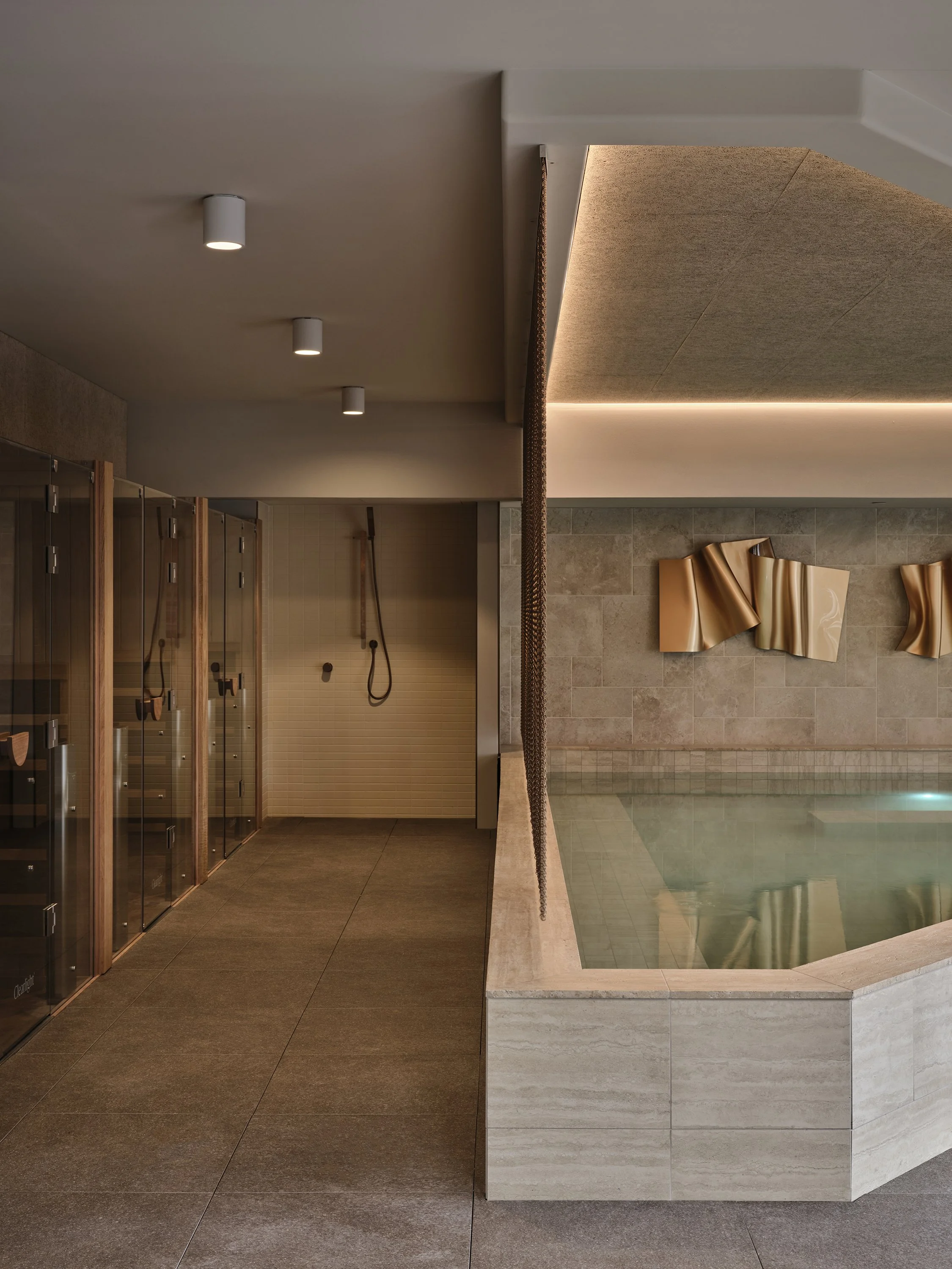 Magnesium plunge pool and sauna wellness space design with natural stone, custom artwork and city views in Melbourne, Docklands.
