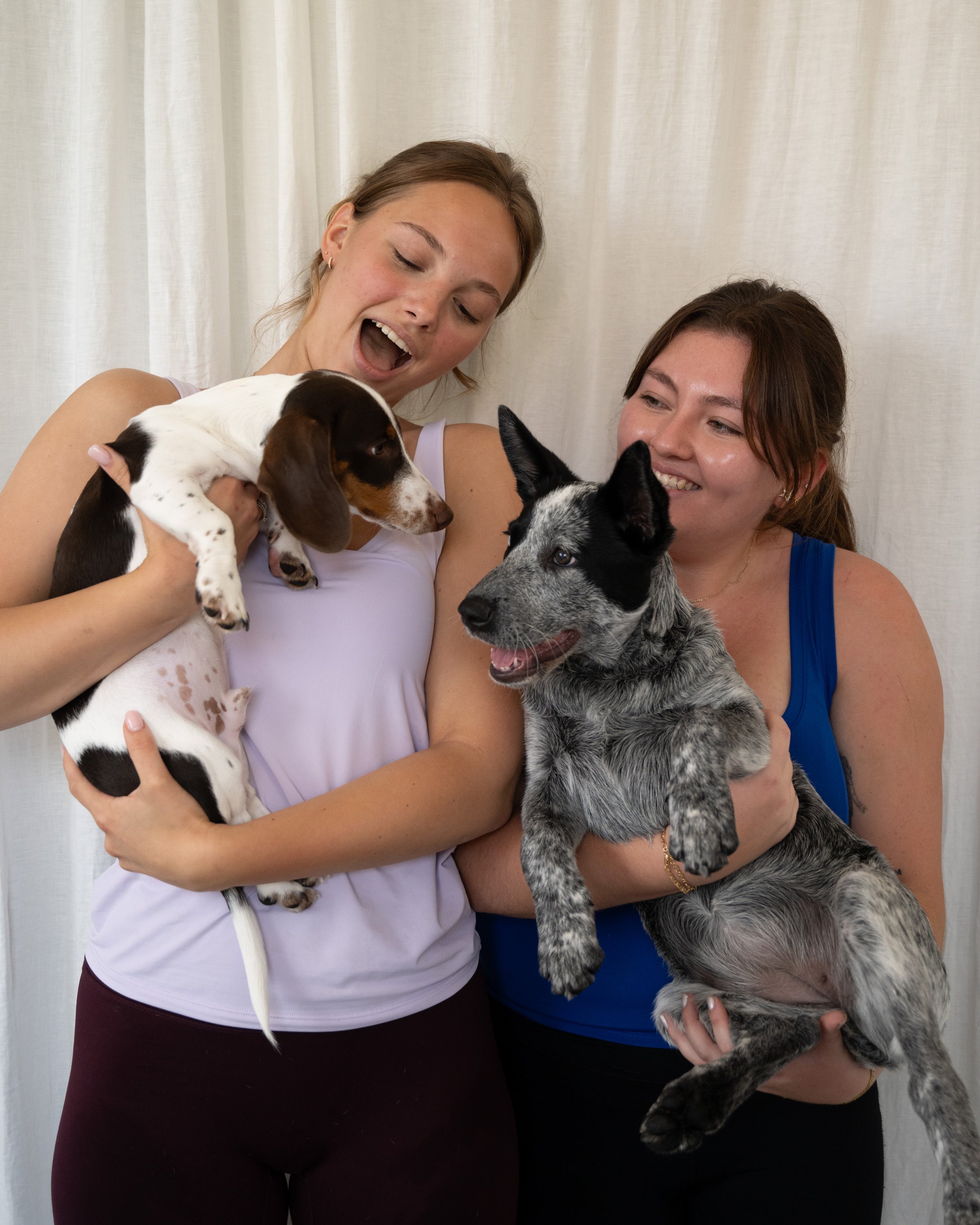 Girls holding puppies