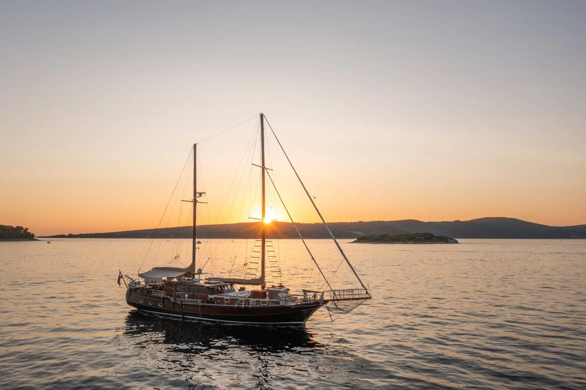 Sailing yacht on calm sea at sunset