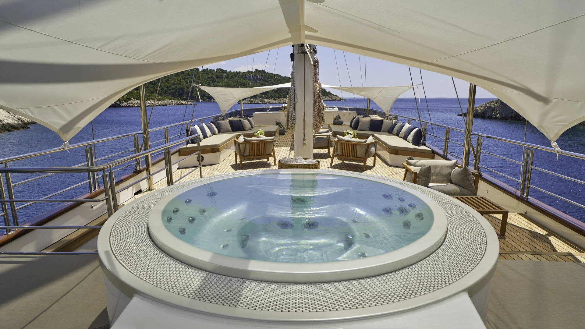 Luxury yacht deck with hot tub, seating area, and ocean view