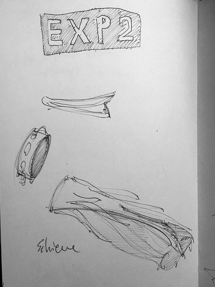 Sketch of objects labeled 'EXP 2' including an aerodynamic shape and a circular item on paper.