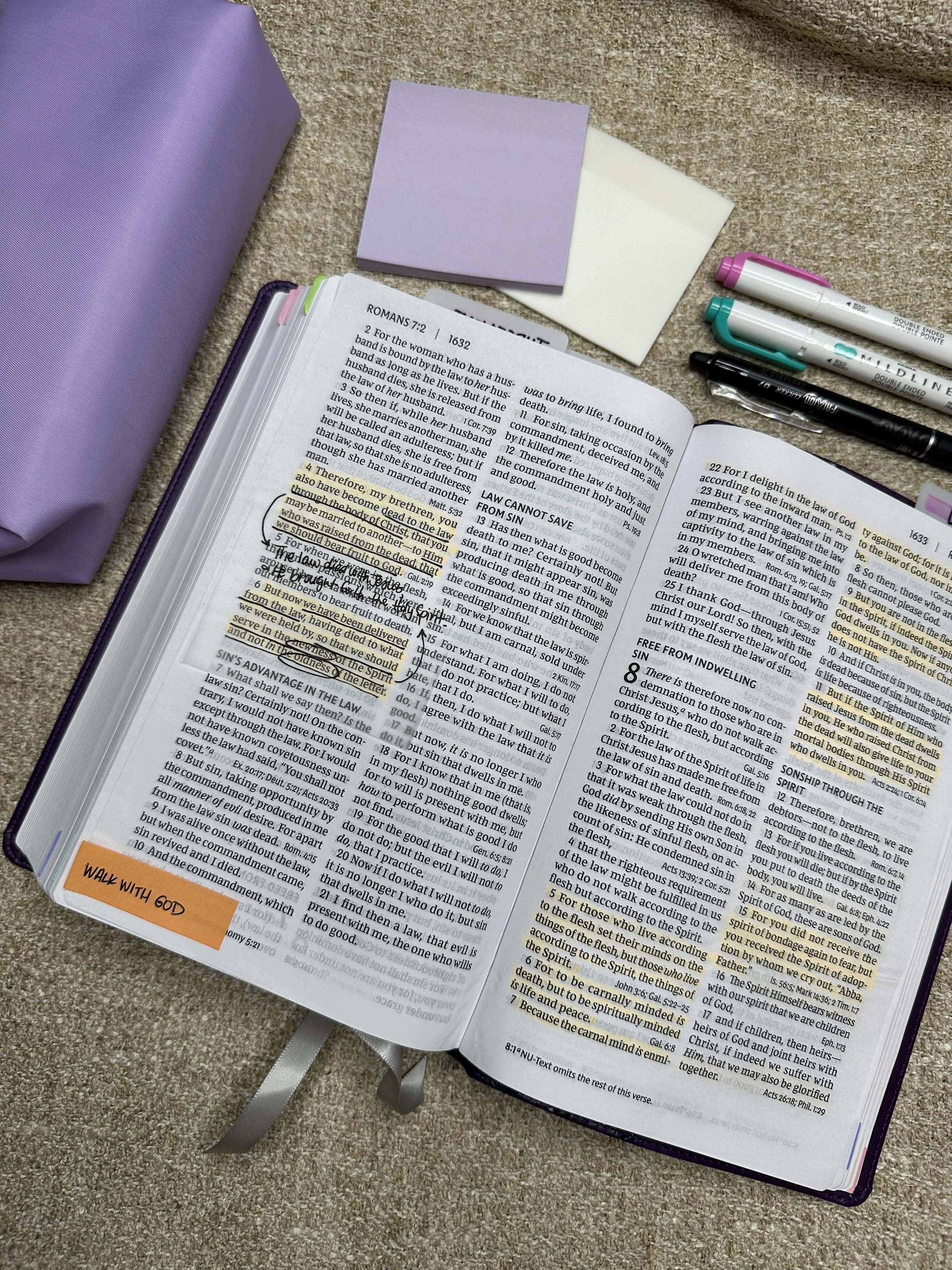 Bible open with highlights and note taking on the page.