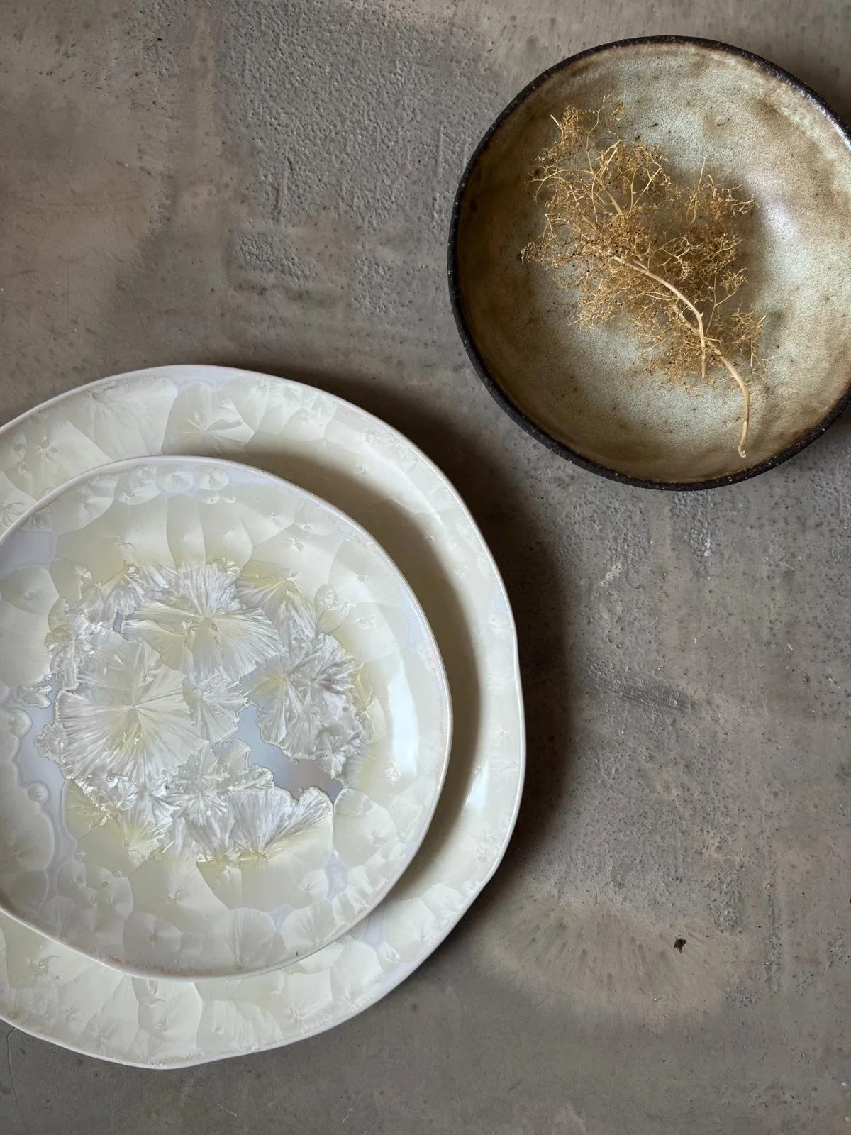 Three cream-colored ceramic plates.