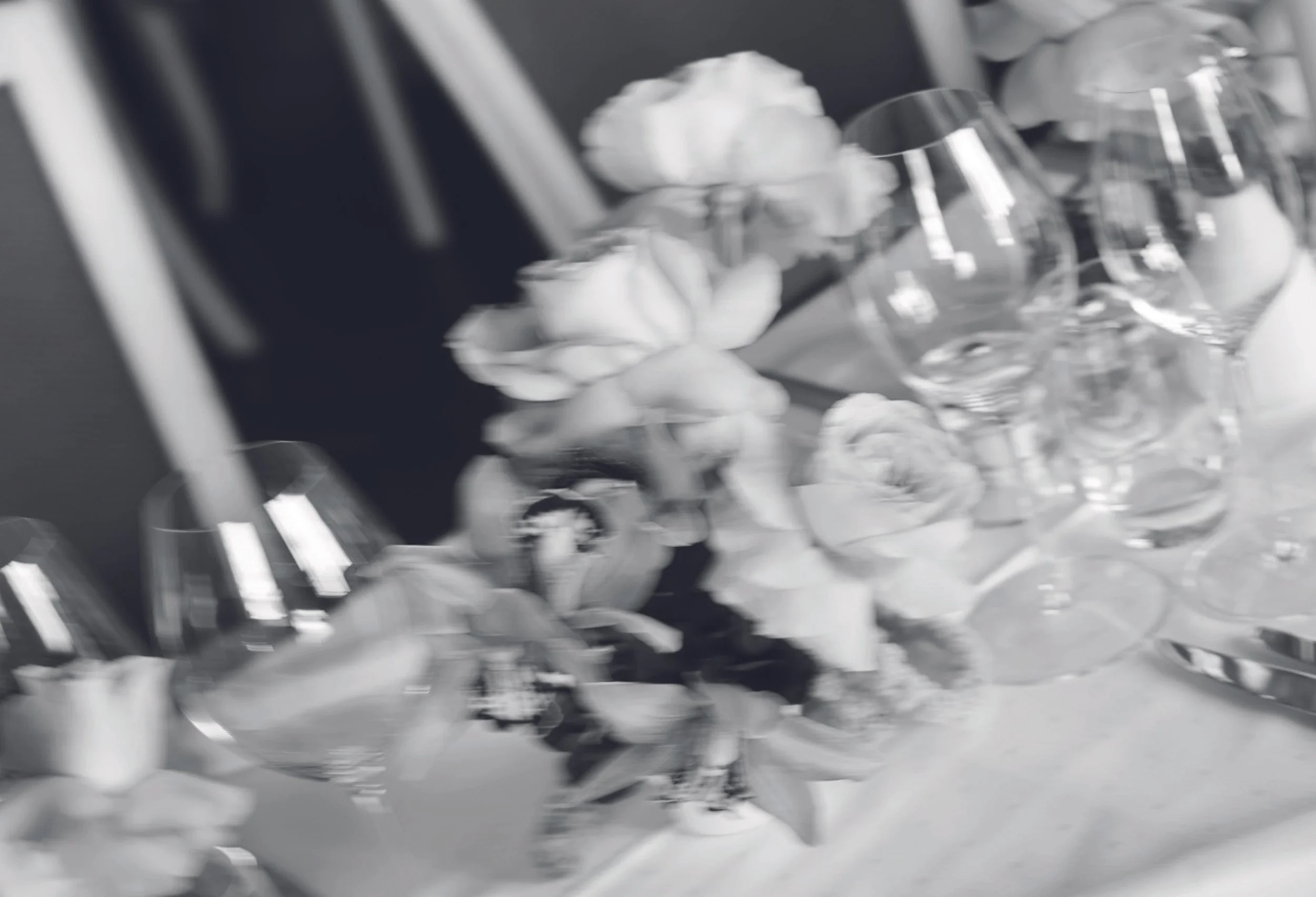 Eine Tischdekoration mit Rosen und Gläsern in schwarz weiss.