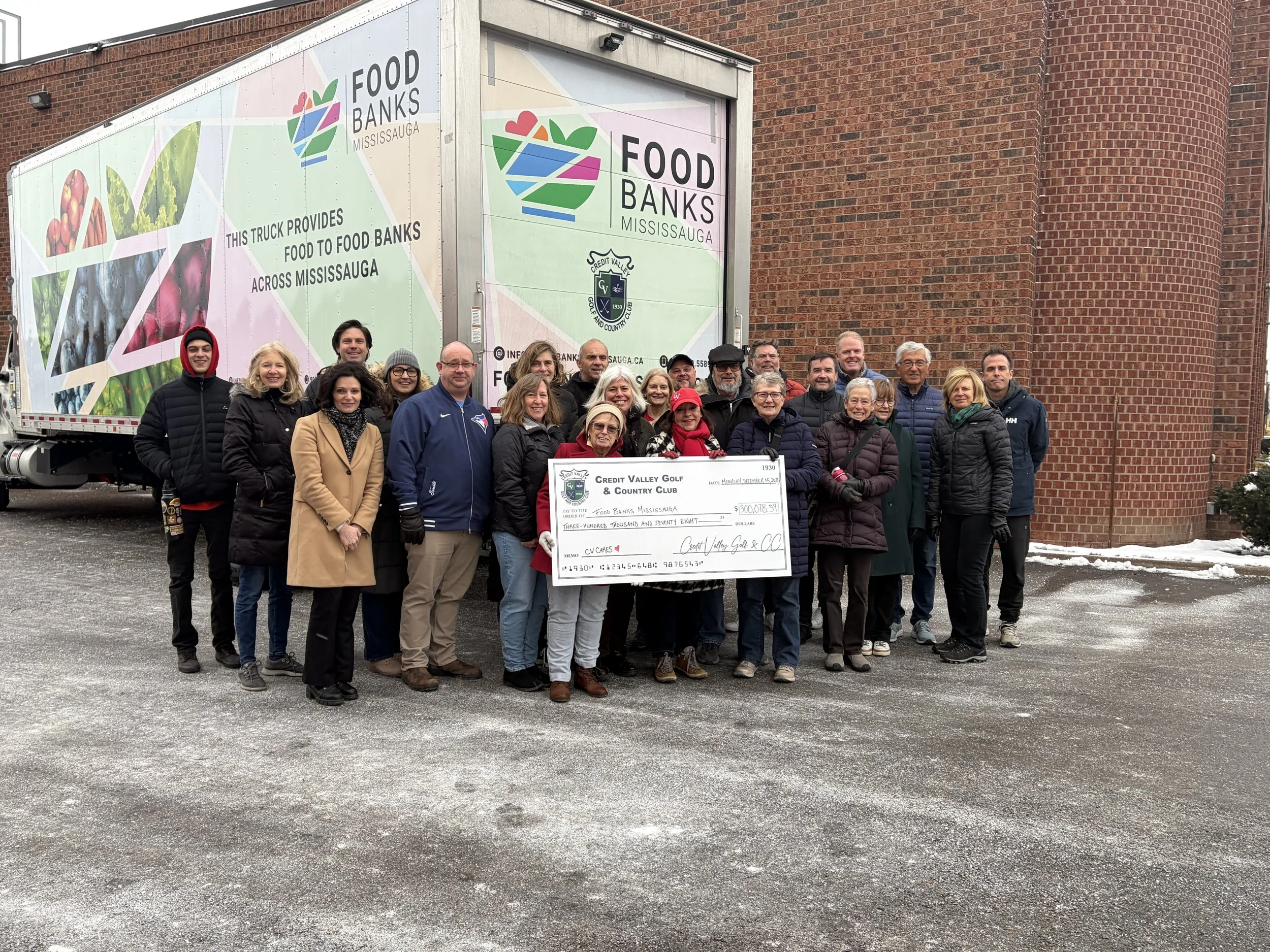 CV member volunteers present FBM with a cheque for $300,000 and take a photo infront of the CV sponsored truck purchased through funds raised.