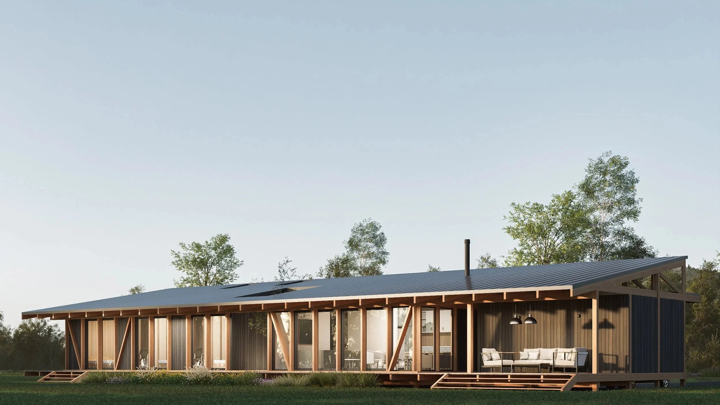 Casa moderna de madera con gran ventana y terraza en un campo con árboles.