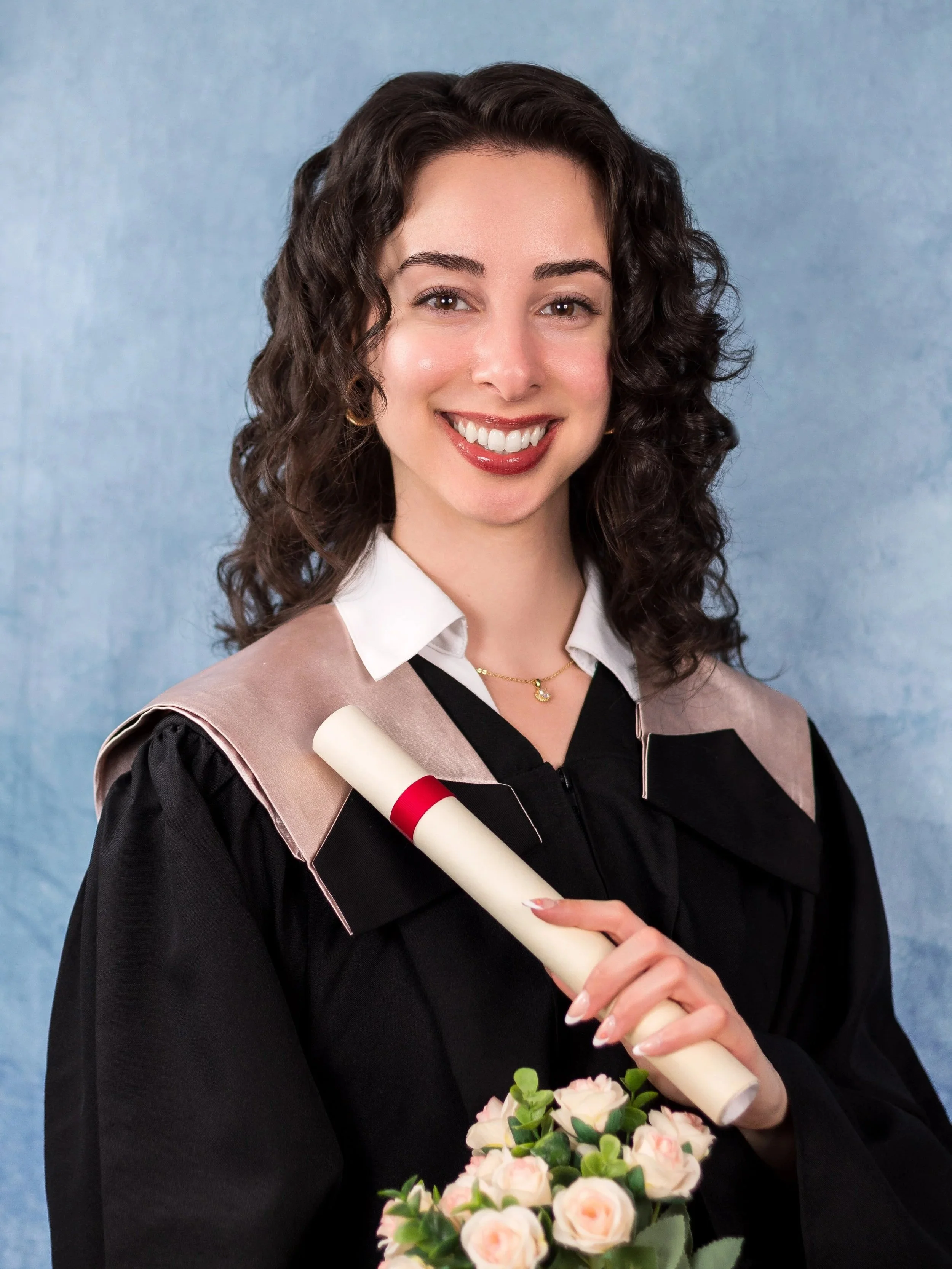 Woman in UOttawa/ University of Ottawa Telfer School of Business robes taking a graduation photo