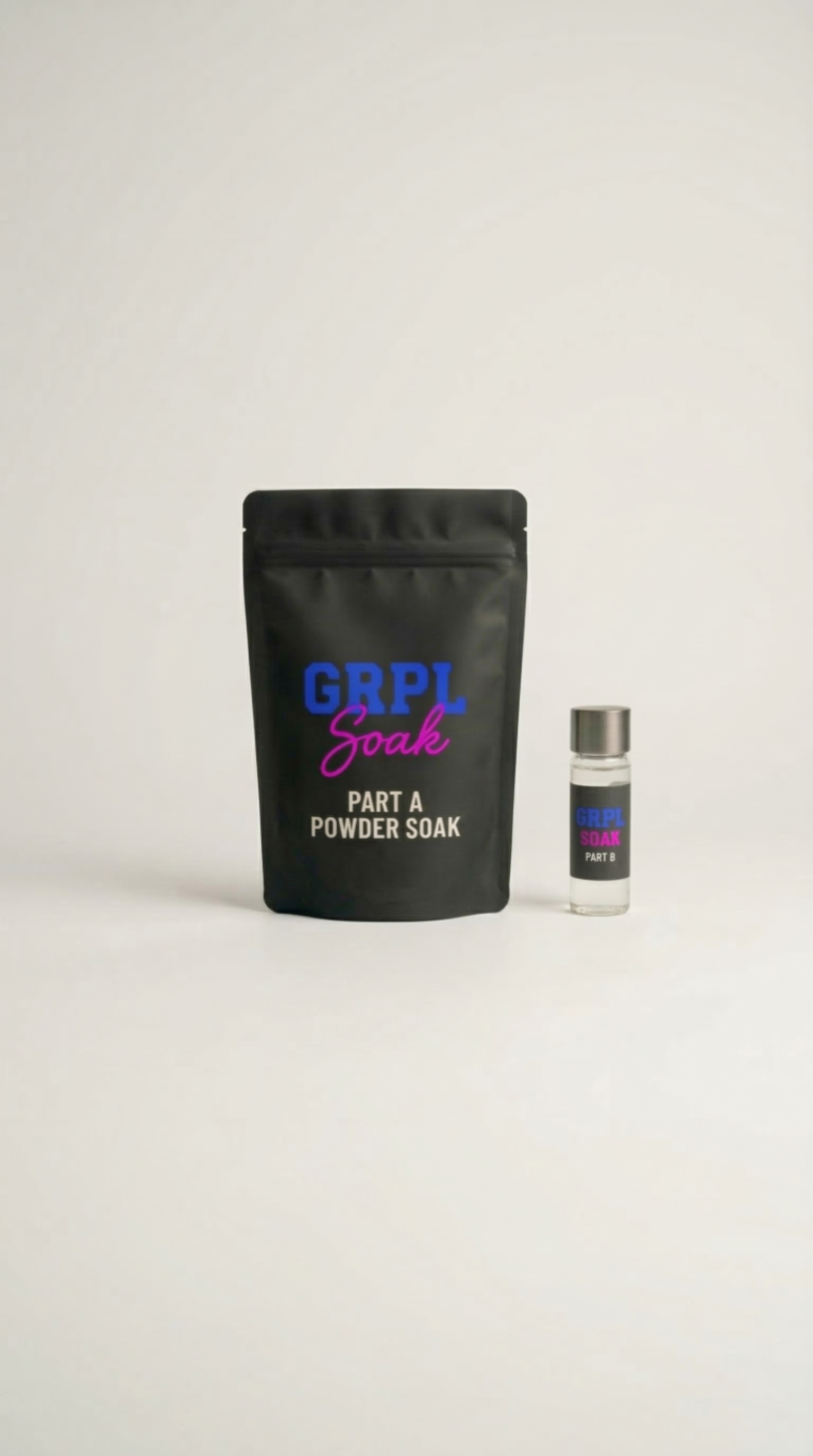 A black pouch labeled "GRPL Soak Part A Powder Soak" and a small vial labeled "GRPL Soak Part B" on a white surface.