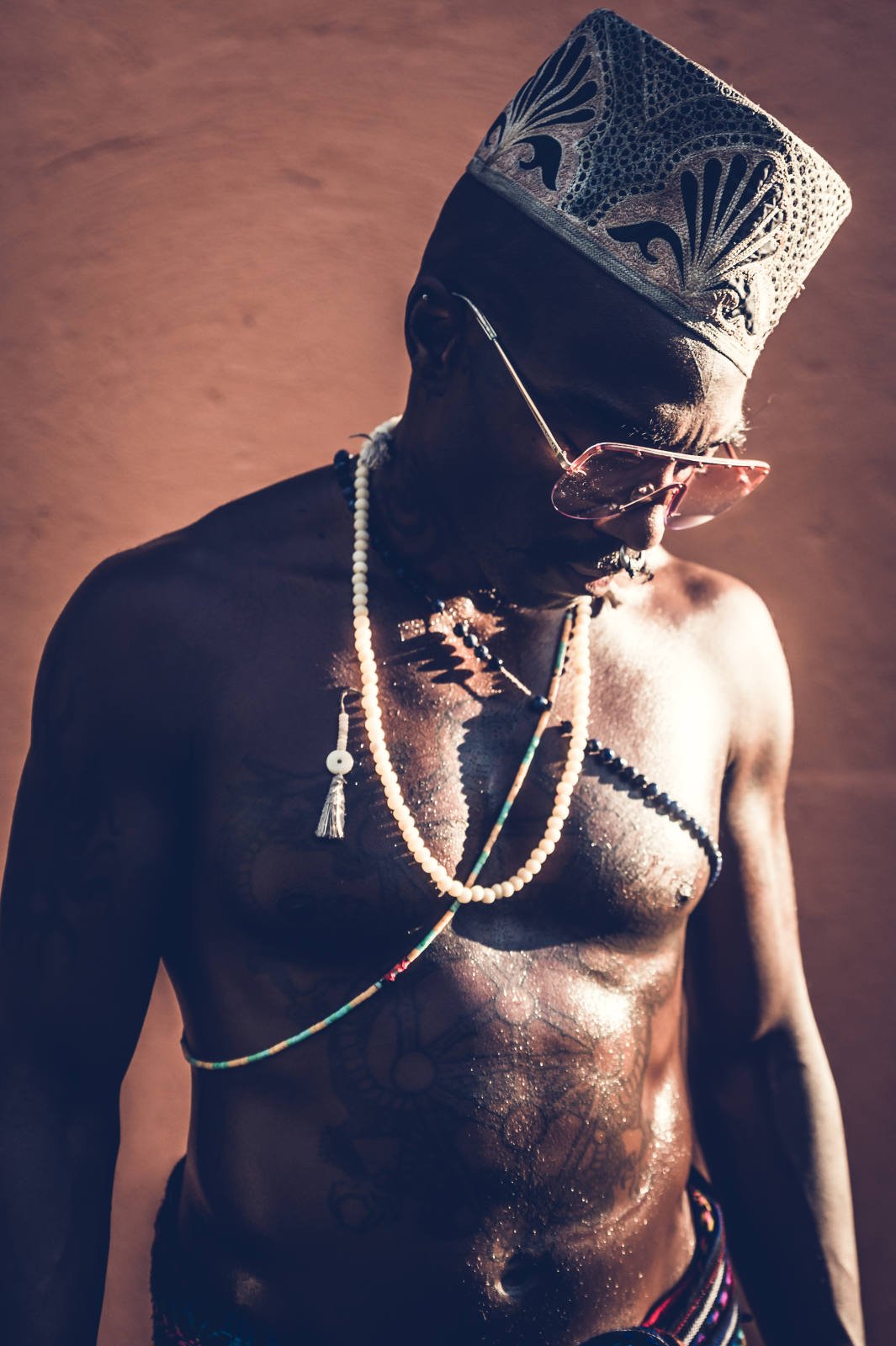 Man wearing traditional hat and beaded necklaces