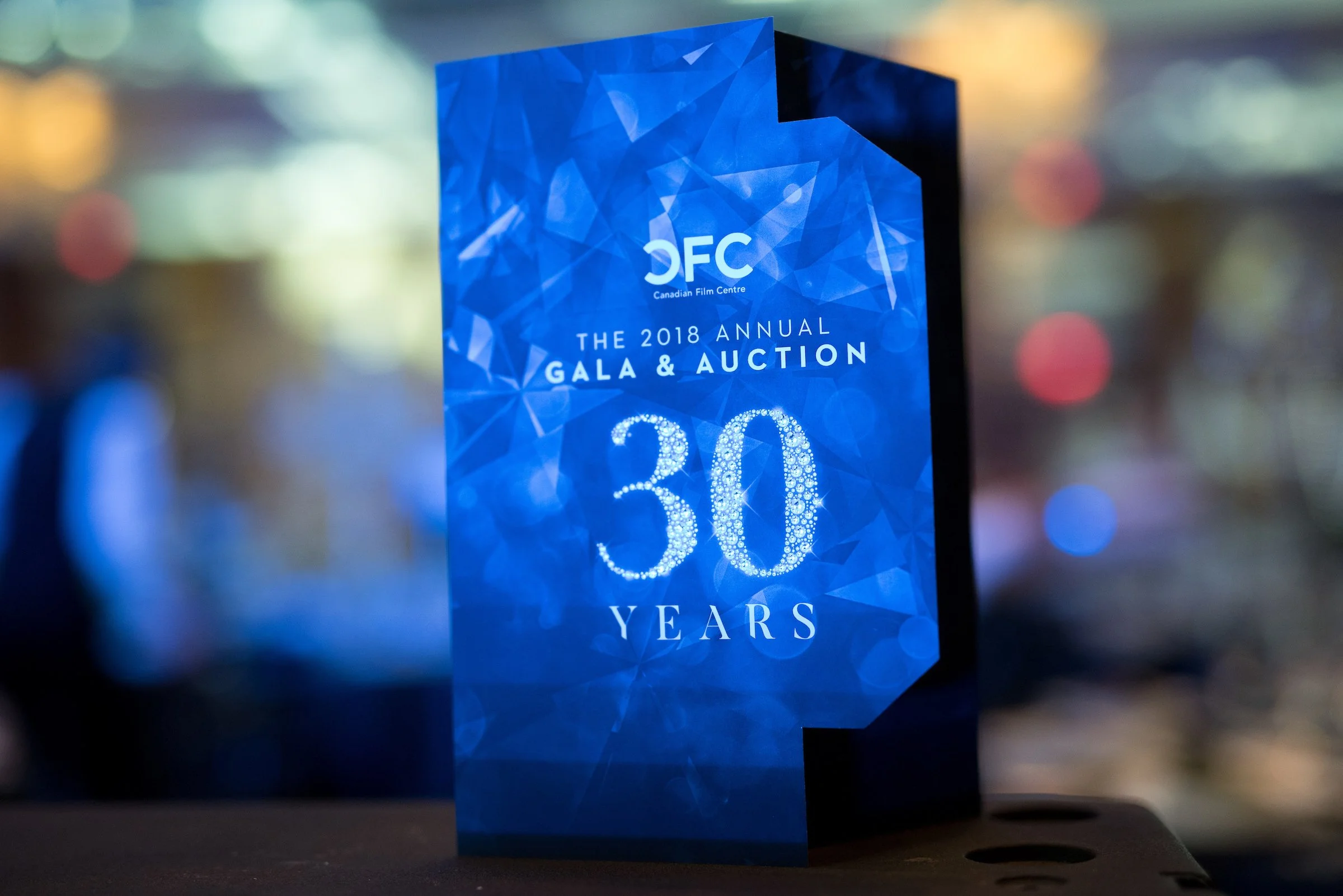 A blue, geometric-designed award or commemorative plaque celebrating 30 years for the 2018 annual gala and auction of the Canadian Film Centre.