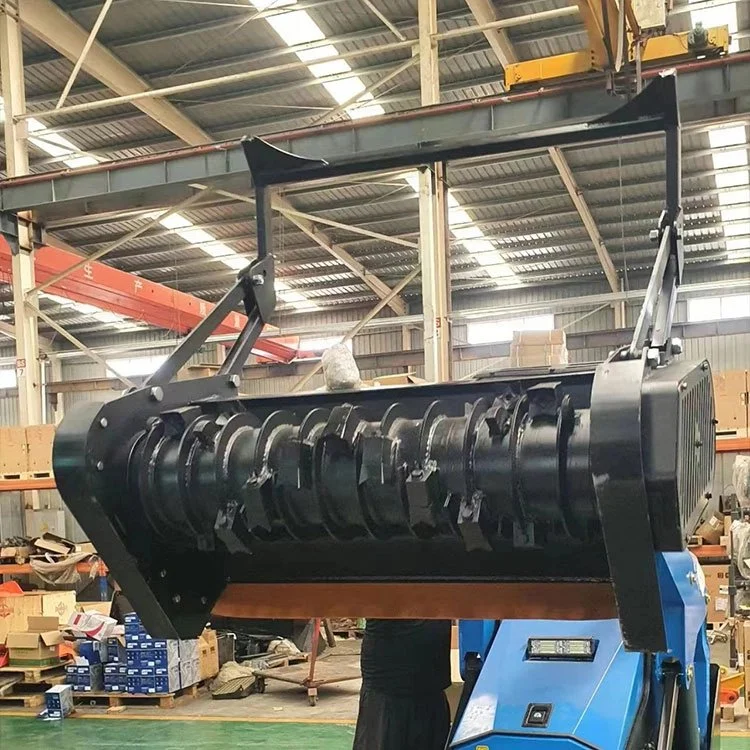 Large industrial machine part, possibly a rotating drum or mulcher, inside a warehouse
