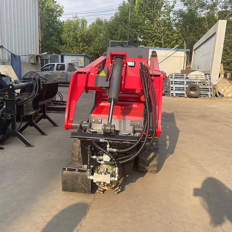 Red mini skid steer loader on concrete surface in industrial yard