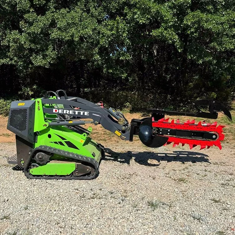 Green mini excavator with trencher attachment on gravel, trees in background.
