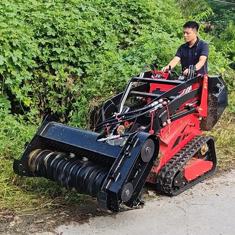 Person operating a red mini tracked mulcher clearing vegetation.