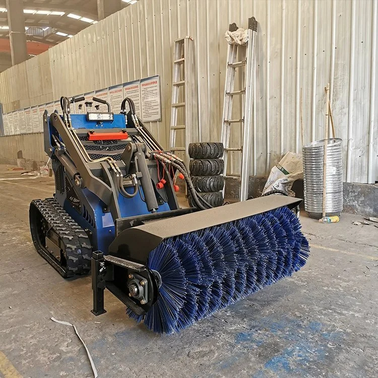 Mini skid steer with brush attachment in a warehouse