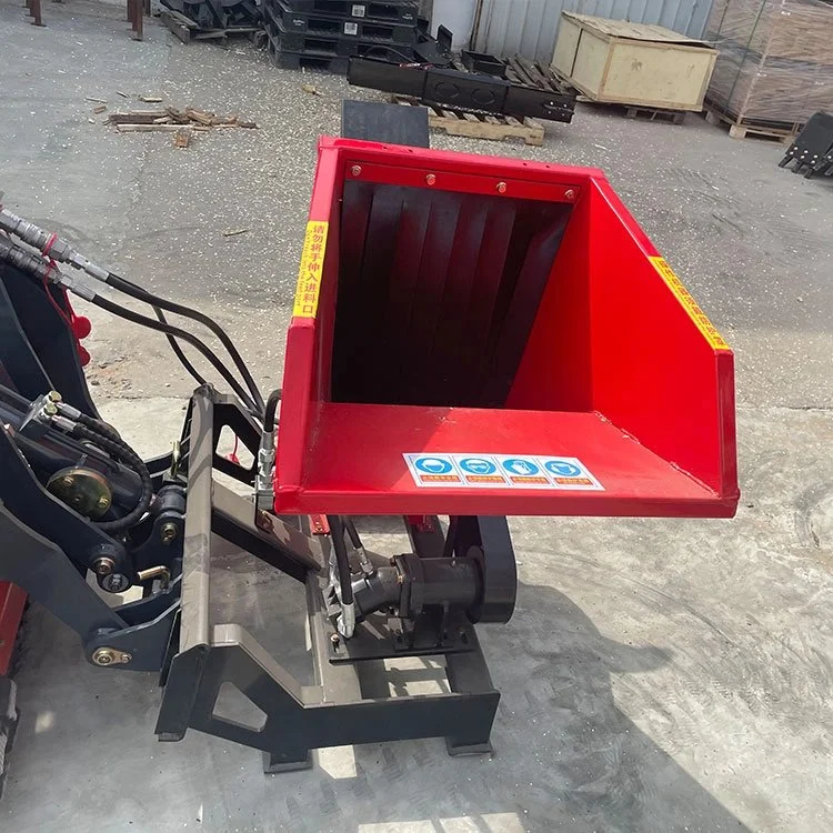 Red industrial wood chipper machine on concrete floor