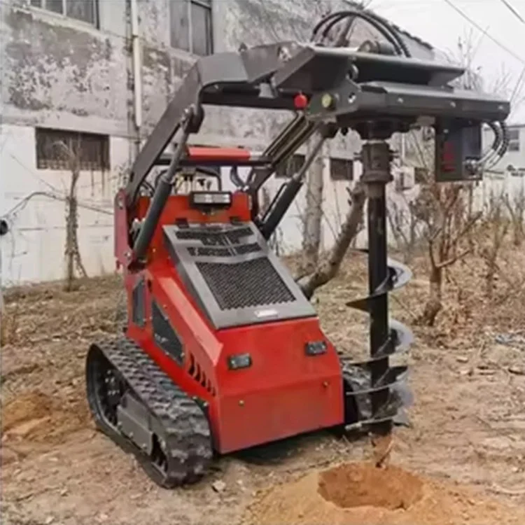 Tracked mini loader with auger attachment drilling hole in dirt.