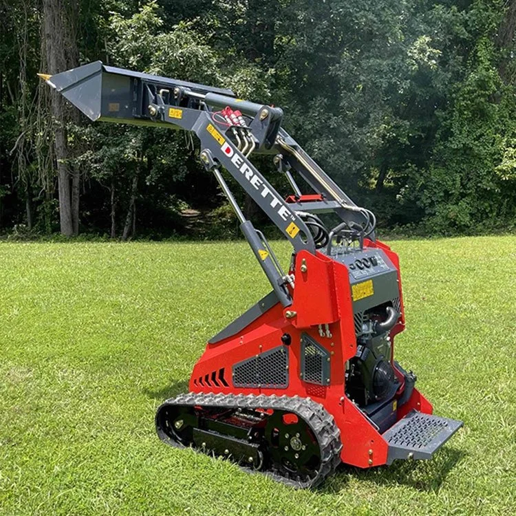 Red mini skid steer loader with bucket on grassy field