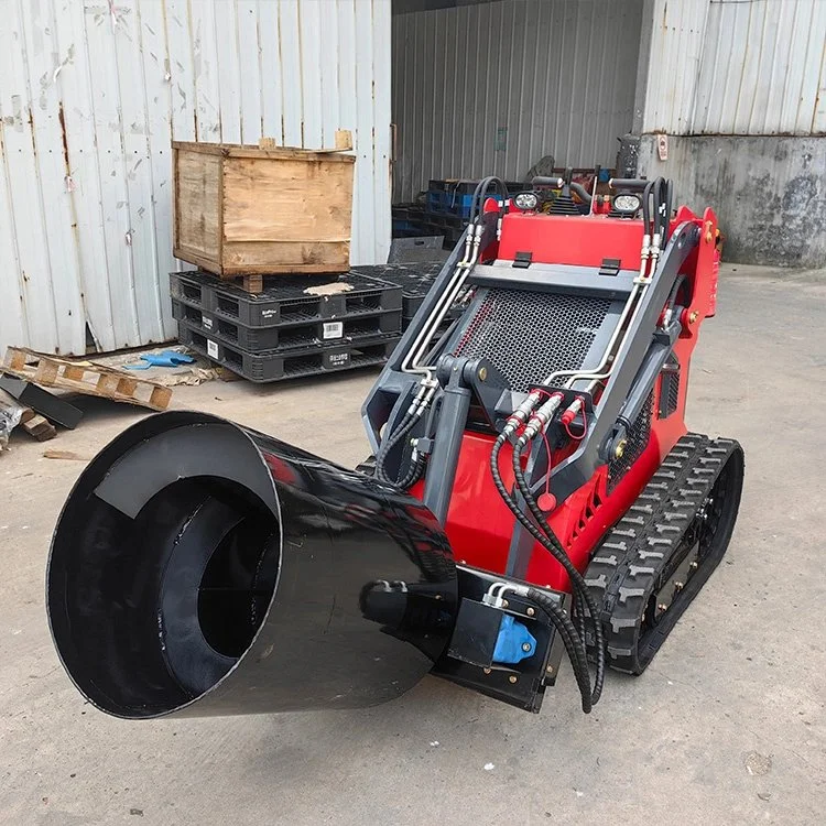 Compact red and black remote-controlled robot vehicle with a large black nozzle attachment, parked in an industrial setting.