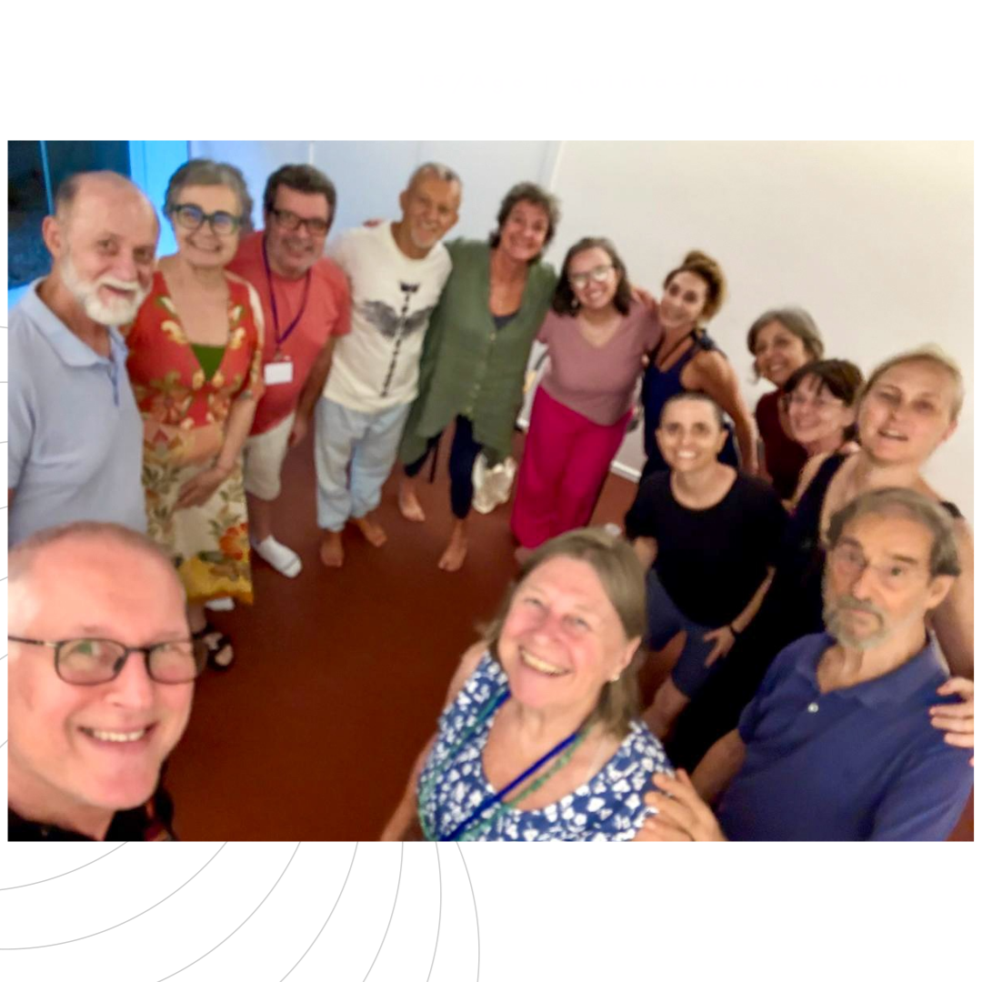 Grupo de pessoas sorrindo, posando para uma foto em um ambiente interno.