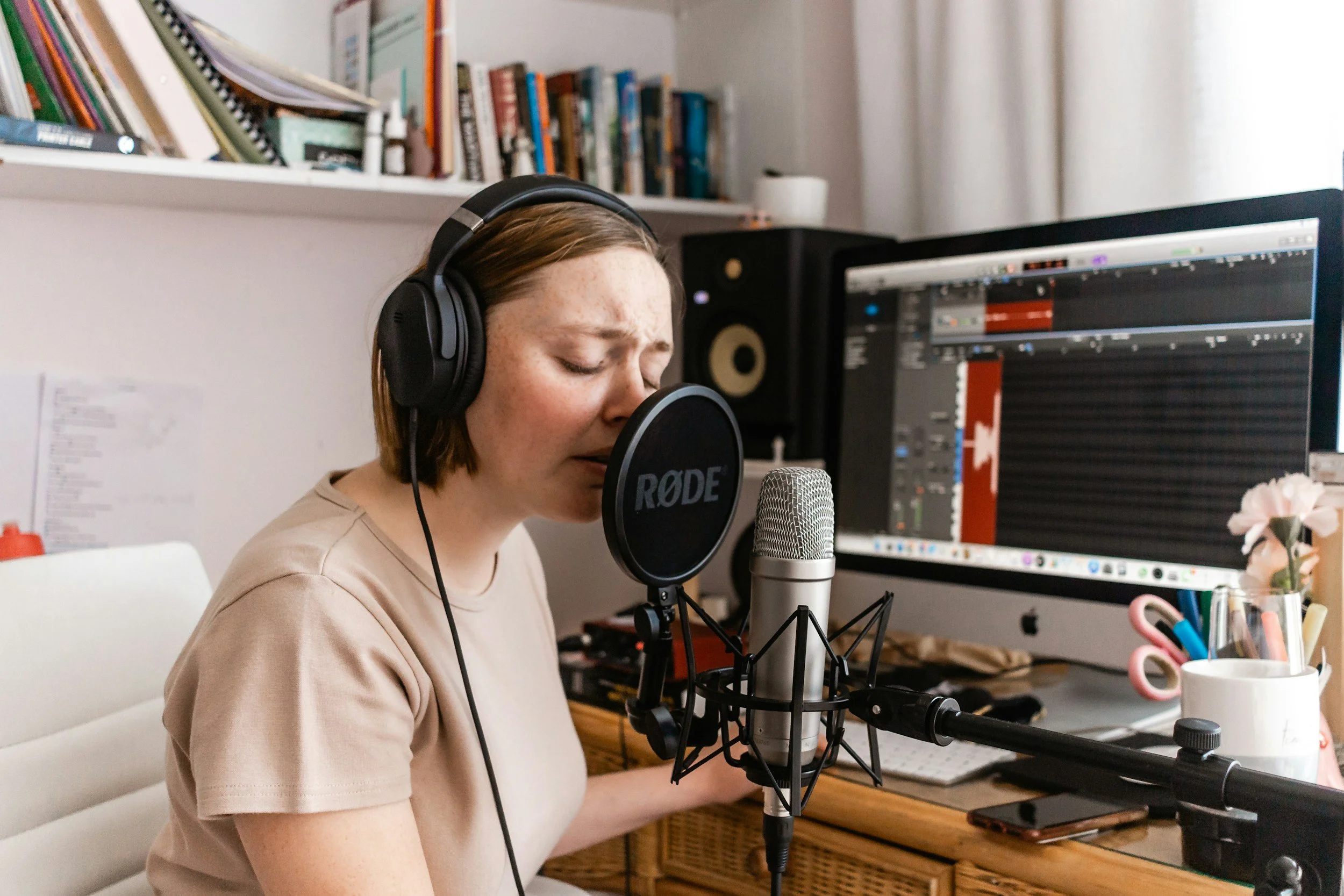 A professional voice actress reading sleep and bedtime stories in the studio that is equipped with high-end studio microphones.
