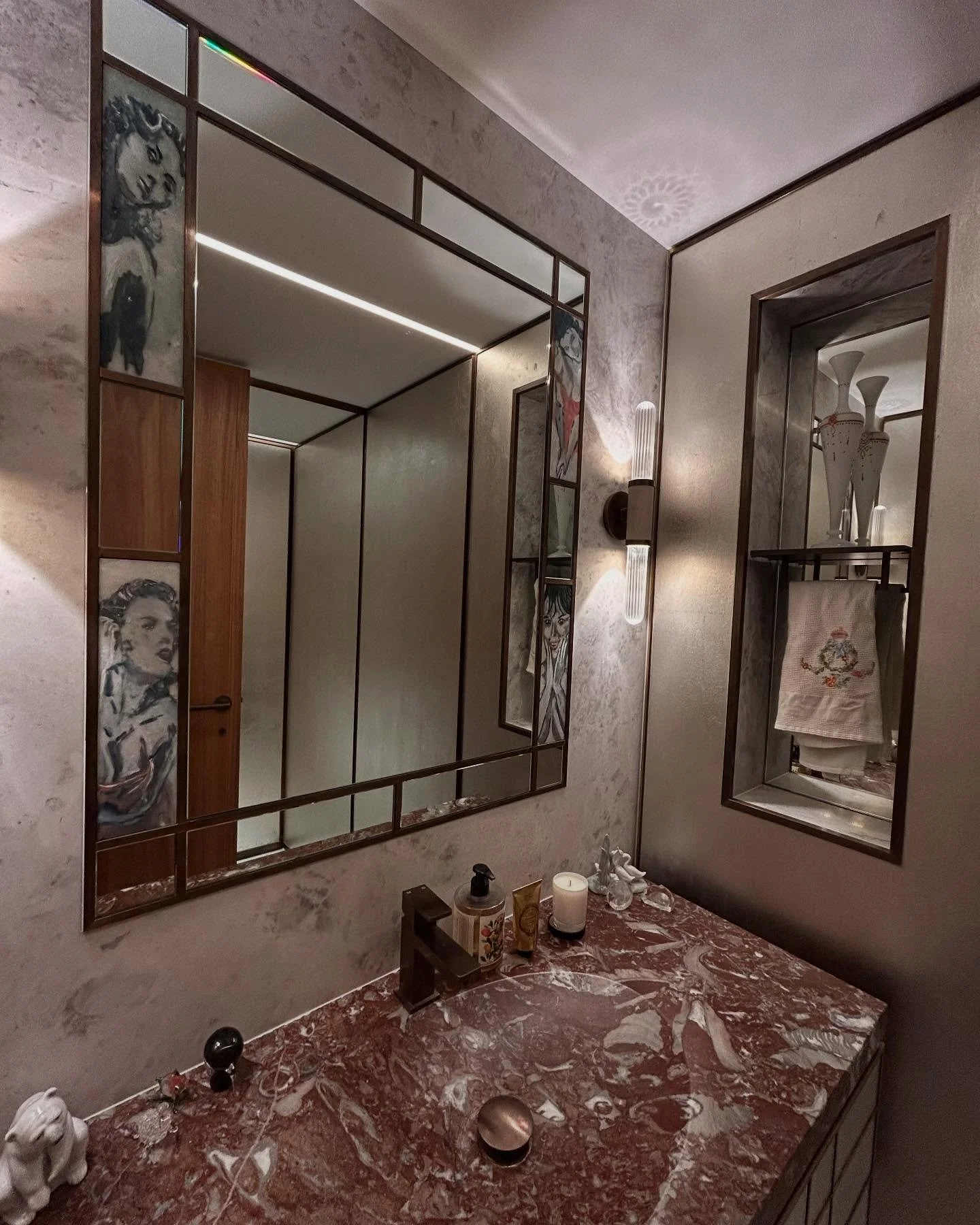 Our Hollywood powder room, where we reused an existing stone vanity basin and incorporated the client&rsquo;s nephews artwork into the mirror design