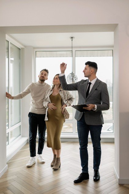 Real estate agent showing a home to a couple, representing a personalized rent versus buy consultation in Mansfield.