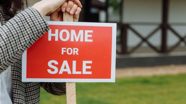 Home for sale sign outside a house, representing a Mansfield seller preparing to calculate net proceeds.