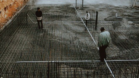 Concrete home foundation slab with rebar on a residential construction site, representing North Texas foundation conditions.