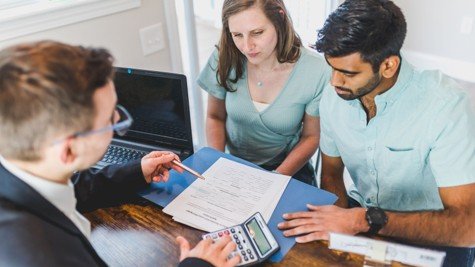 Real estate agent reviewing a Texas home purchase contract with buyers during an option period discussion.