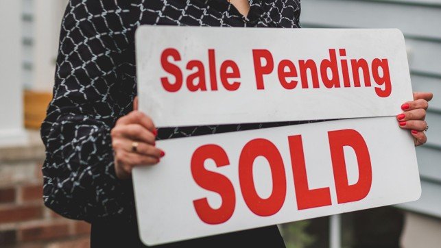 Sale pending and sold signs representing a Mansfield home sale moving toward closing.