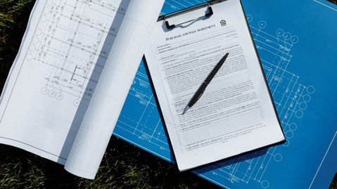 Survey blueprints and real estate contract paperwork for a Mansfield home purchase.