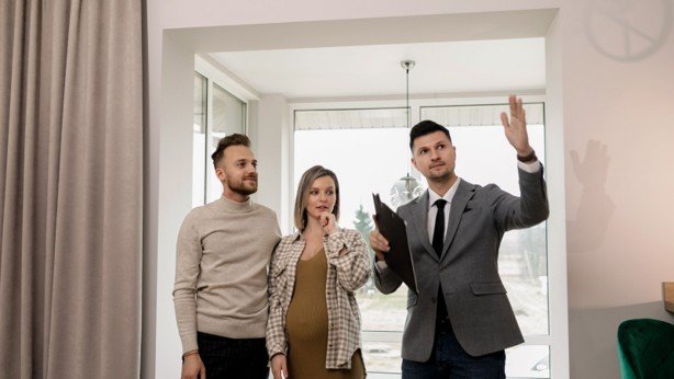 Real estate agent showing a house to first-time buyers during a Dallas-Fort Worth home tour.