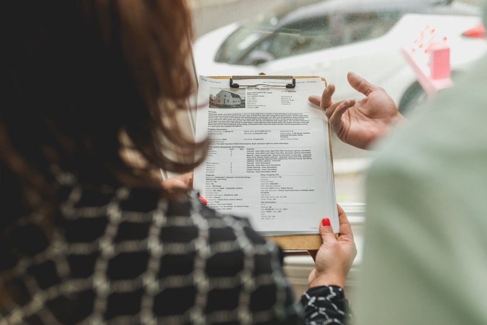 First-time home buyers meeting with a real estate professional to review documents and mortgage options.