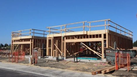 New residential home framing under construction, representing Mansfield new construction communities.