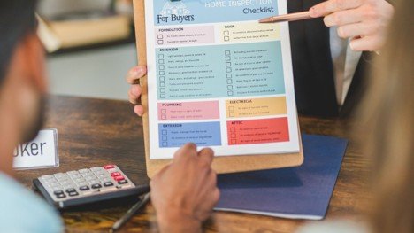 Close-up of a real estate disclosure checklist and calculator for a Mansfield home sale.