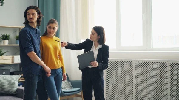 Real estate agent showing a home to first-time buyers while discussing USDA loan options near DFW.