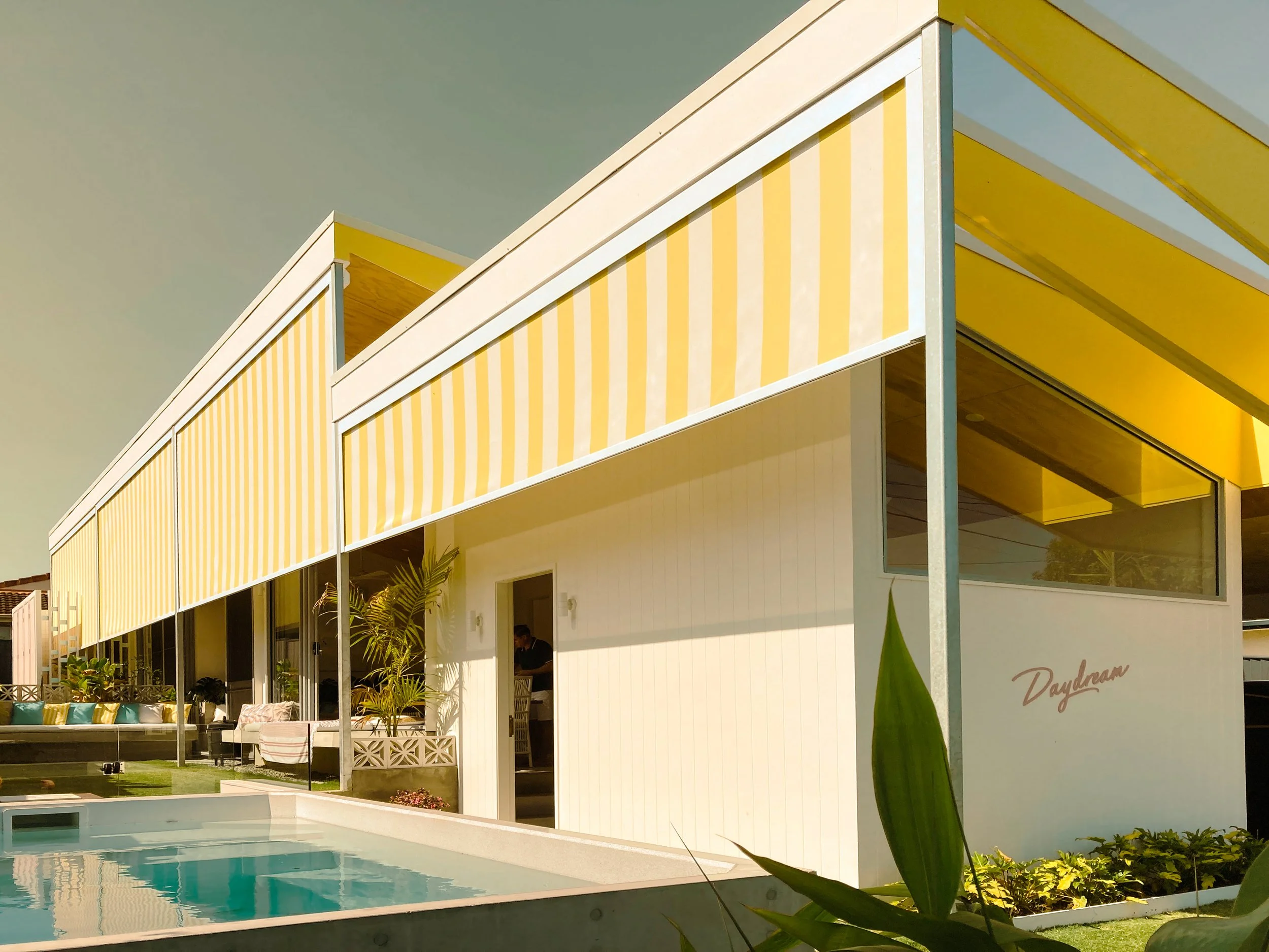 Daydream House by Goldie Homes, showing the front courtyard, plunge pool and striped facade