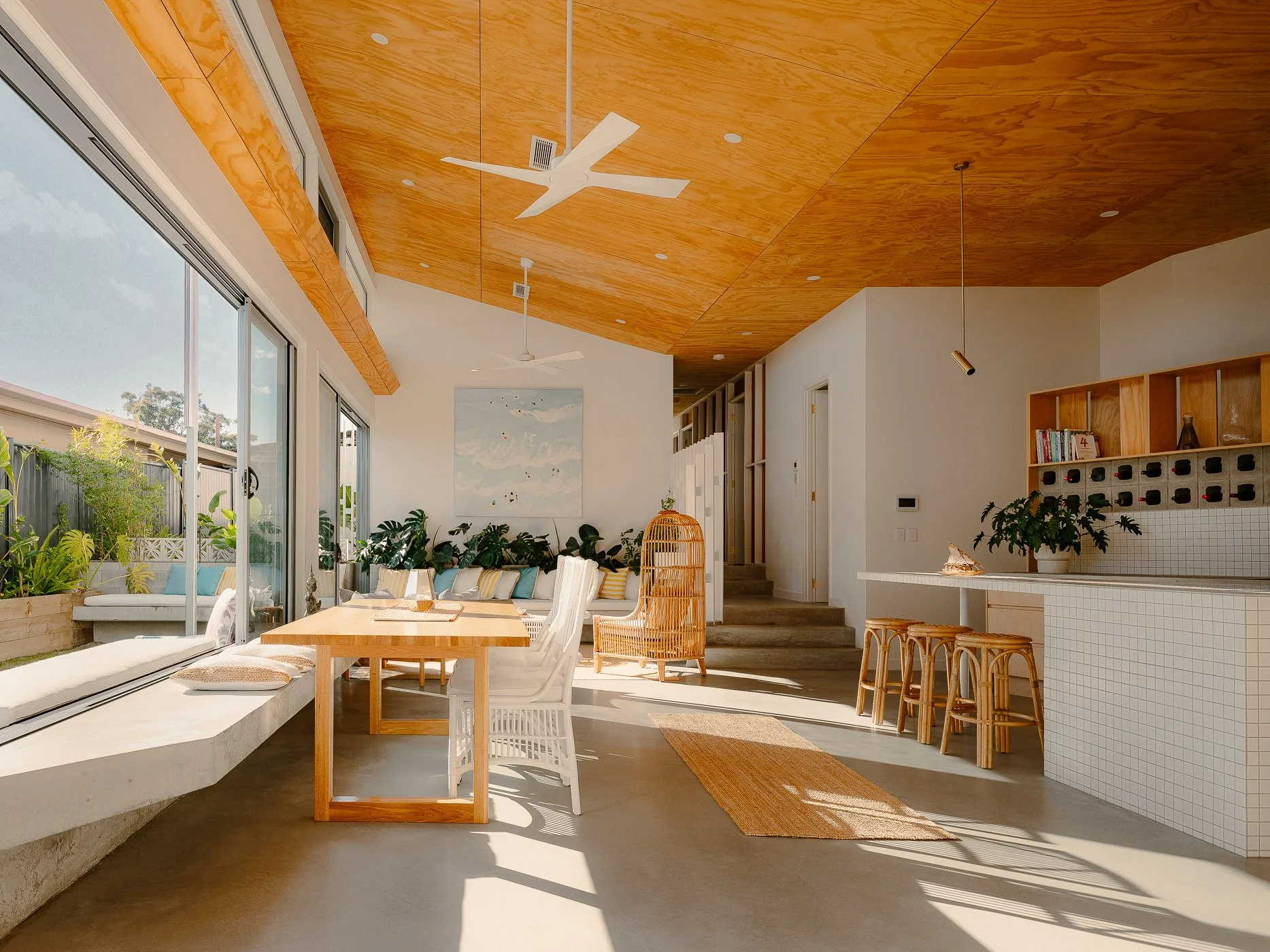 Open-plan dining and living space at the Daydream House with timber ceiling, indoor-outdoor connection and passive design features