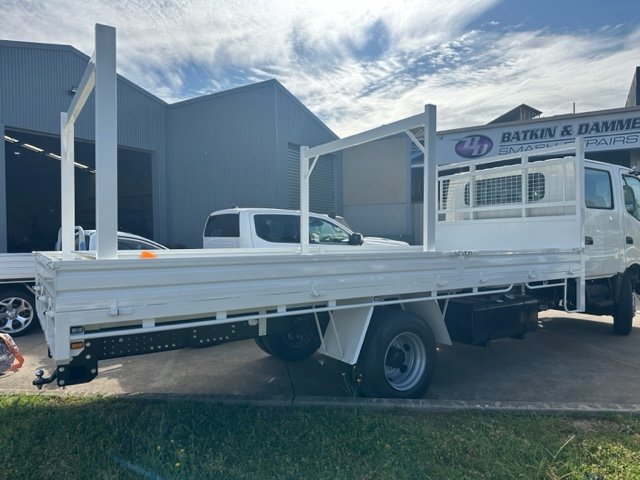 White flatbed truck with metal framework on the sides, custom ute tray and powder coating Wagga Wagga. Sandblasting and powder coating service Wagga with custom truck and ute bodies and ute trays. 