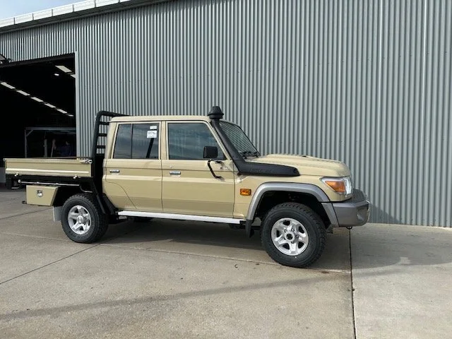 Tan pickup truck ute with a black tray, custom fabricated ute tray flatbed. Powder coated and sandblasted, and installed. Custom designed and welded ute tray.