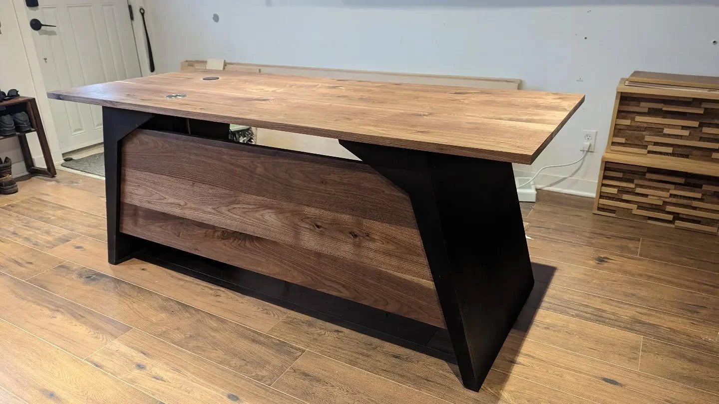 My last custom furniture for 2022!
Walnut study desk with angled handcrafted legs.
There's a built in wireless cellphone charger and a electronic pop up electric plug.
Top finished with Rubio monocoat.
The legs are baltic birch Stained with Rubio's