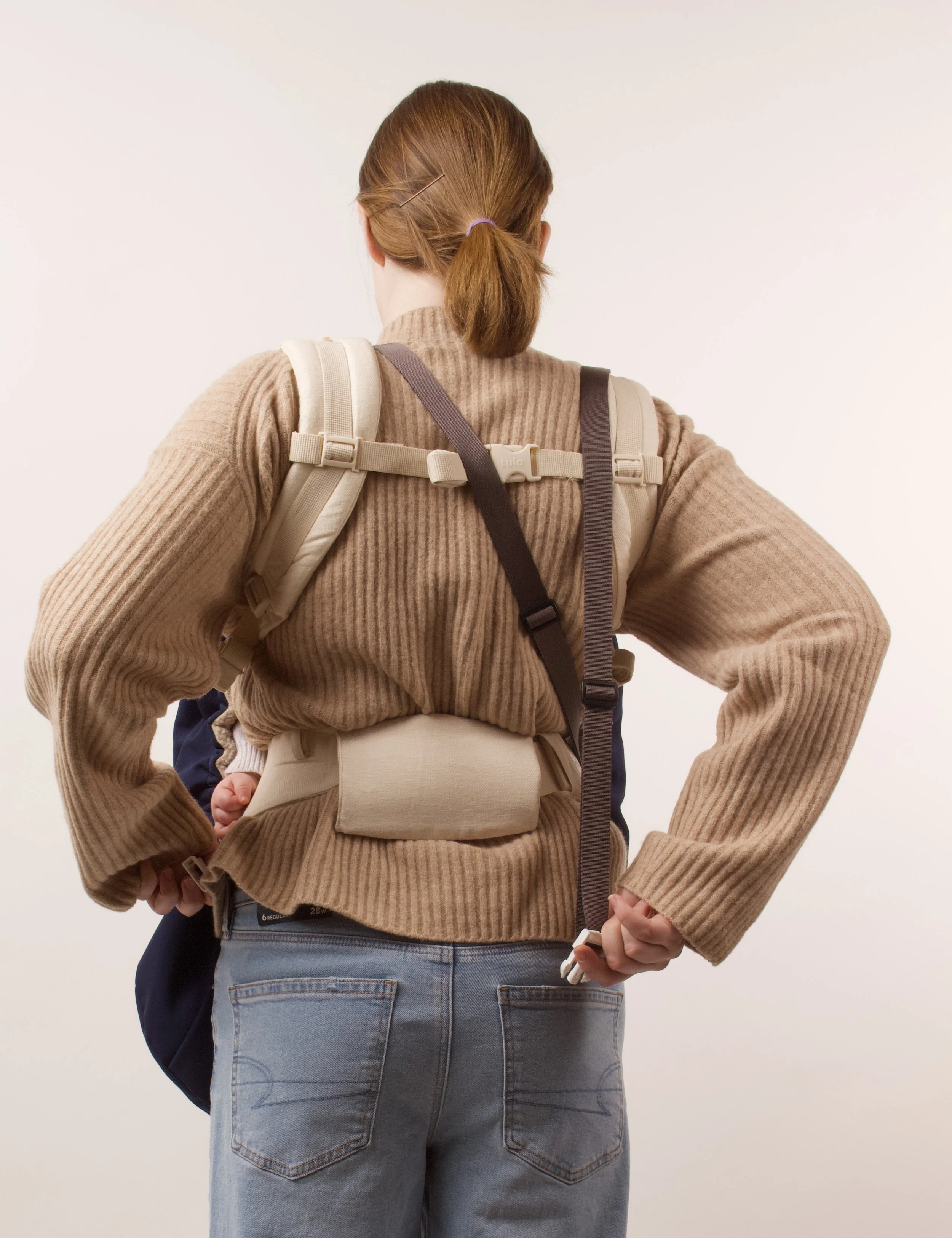 Grab strap from behind and pull diagonally across back