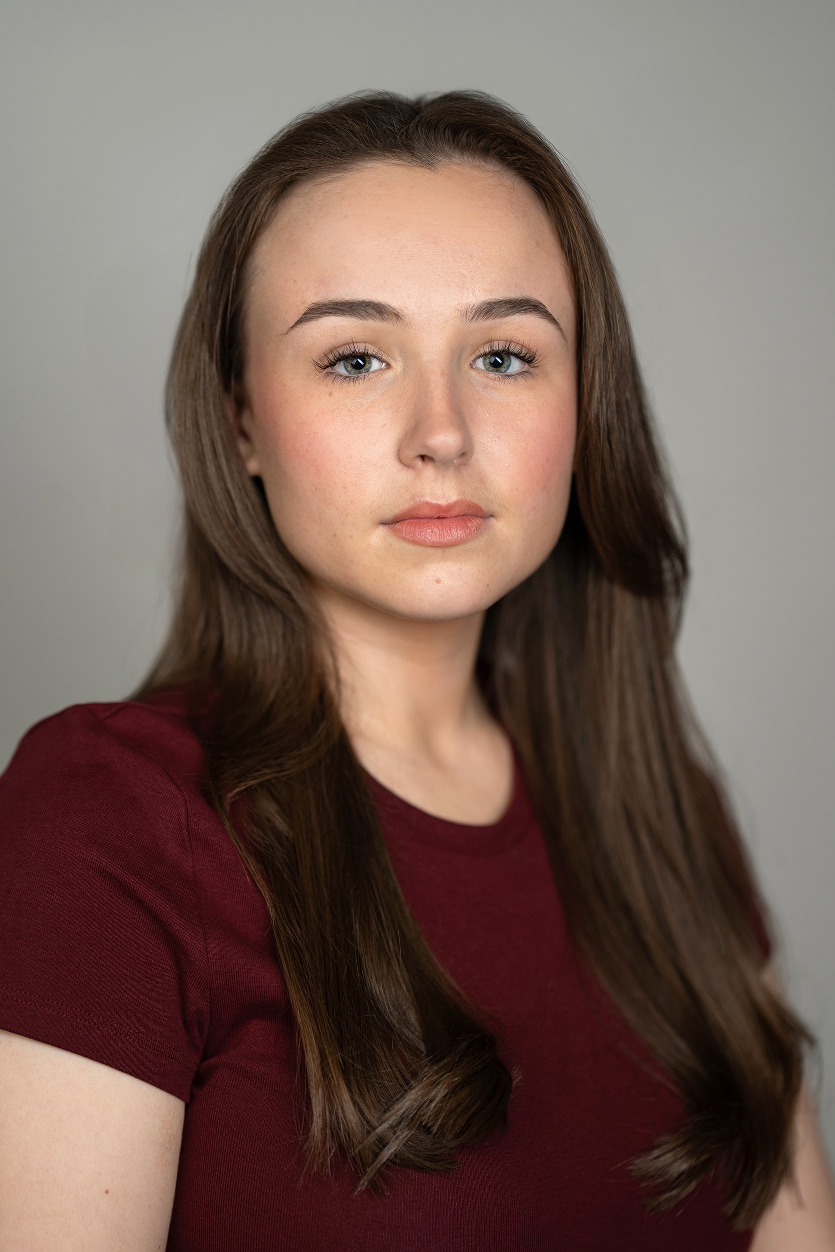 A young woman captured during a professional headshot photoshoot
